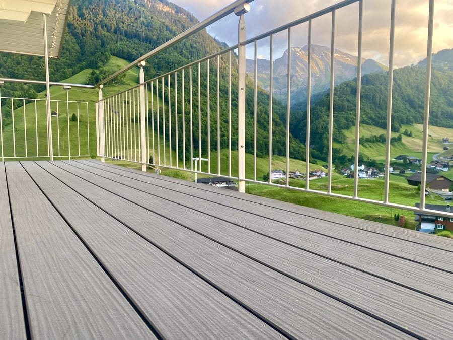 megawood Premium decking on a balcony with a mountain view (reference photo)