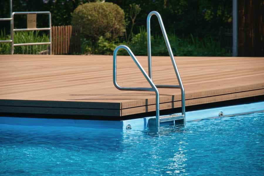 megawood deck around a pool, with a ladder (manufacturer photo)